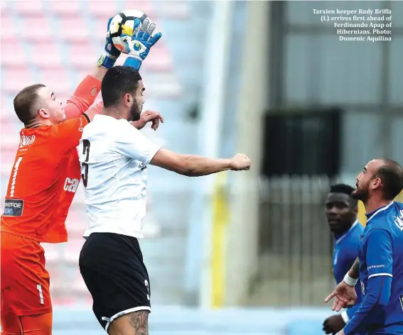  ??  ?? Tarxien keeper Rudy Briffa (L) arrives first ahead of Ferdinando Apap of Hibernians. Photo: Domenic Aquilina