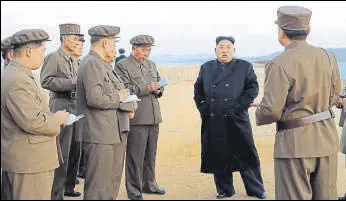  ?? AP ?? In this photo released on Friday by the North Korean government, the country’s leader Kim Jong Un listens to a military official at the Academy of National Defence Science in Pyongyang.