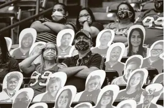  ?? Brett Coomer / Staff photograph­er ?? The NFL has found a way to keep playing, even if in front of limited numbers of fans amid cardboard cutouts such as these at NRG Stadium earlier this season.