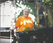  ??  ?? Thomas holds a tray of pepper plants while working in his garden Aug. 11 in Janesville, Wis.
(The Janesville Gazette /Anthony Wahl)