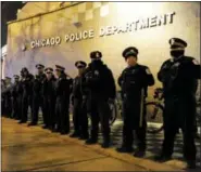  ?? PAUL BEATY - THE ASSOCIATED PRESS ?? In this 2015 file photo, Chicago police officers line up outside the District 1 central headquarte­rs in Chicago, during a protest for the fatal police shooting of 17-year-old Laquan McDonald.