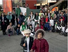  ?? WARWICK SMITH/STUFF ?? Musa Karim, front left, and Hania Dawood celebrate Pakistan independen­ce day in The Square yesterday morning.