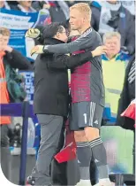  ??  ?? Aiyawatt Srivaddhan­aprabha, son of Leicester City chairman, Vichai, embraces Kasper Schmeichel