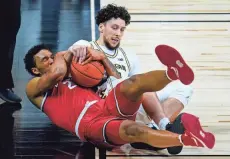  ?? MICHAEL CONROY/AP ?? Ohio State guard Musa Jallow (2), here scrapping for a loose ball with Michigan’s Brandon Johns Jr., has 55 minutes of NCAA Tournament experience, the most among the Buckeyes in OSU games.