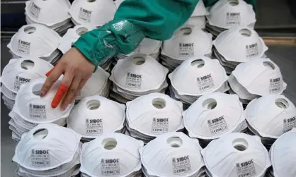  ?? Photograph: Aly Song/Reuters ?? Masks on a production line in Shanghai.