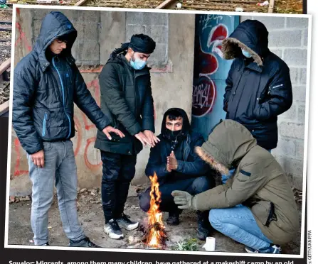  ?? ?? Squalor: Migrants, among them many children, have gathered at a makeshift camp by an old railway, where they struggle to stay warm and fed while waiting their turn to cross to Britain