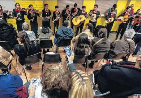  ?? Photograph­s by Maria Alejandra Cardona Los Angeles Times ?? A YOUTH mariachi band performs for reunited families at Spane Park in Paramount in January. Since the Palomas Mensajeras program started last year, it has helped more than 1,000 parents from the Mexican state of Michoacán visit children living in...