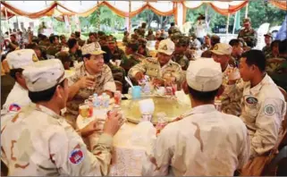  ?? FACEBOOK ?? Cambodian Navy officials drink beer as they enjoy a lunch break after a closed-door meeting with Prime Minister Hun Sen yesterday in Stung Treng province.