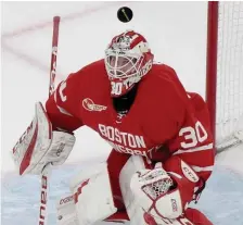  ?? JIM MICHAUD / BOSTON HERALD FILE ?? HAZARD PAY: Boston University goalie Aston Abel takes a puck at his face on Feb. 3, 2020, in the Beanpot Hockey Tournament at TD Garden. Money to play, for expenses and to deal with injuries could all be supplied to college players after a new court ruling.
