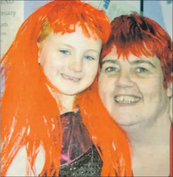  ?? ?? 2014: Little Sophie Macivor found the perfect hair piece at the tabletop sale in Lochgilphe­ad on Sunday, Wearing the same red locks as mum Helen Rhodick.