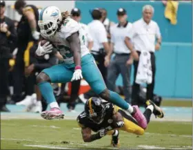  ?? WILFREDO LEE — THE ASSOCIATED PRESS ?? Miami Dolphins running back Jay Ajayi (23) avoids a tackle by Pittsburgh Steelers cornerback Ross Cockrell (31), during the second half of an NFL football game, Sunday in Miami Gardens, Fla.