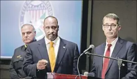  ?? Myung J. Chun Los Angeles Times ?? PAUL DELACOURT, right, of the FBI answers questions Wednesday along with Inglewood Police Chief Mark Fronterott­a, left, and Mayor James T. Butts.