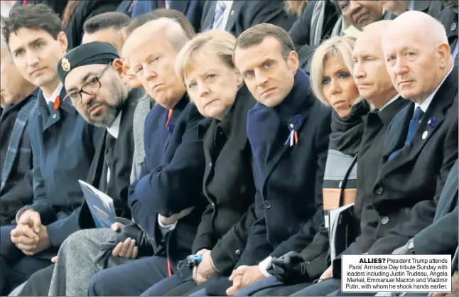  ??  ?? ALLIES? President Trump attends Paris’ Armistice Day tribute Sunday with leaders including Justin Trudeau, Angela Merkel, Emmanuel Macron and Vladimir Putin, with whom he shook hands earlier.