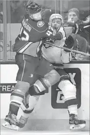  ?? Mark J. Terrill Associated Press ?? KINGS DEFENSEMAN Alec Martinez gets taken hard into the boards by Ducks defenseman Josh Manson during the first period at Honda Center.