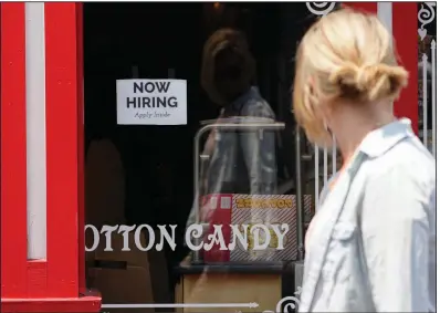  ?? (AP/Rich Pedroncell­i) ?? A “now hiring” sign is posted last month in the window of The Wharf Chocolate Factory at Fisherman’s Wharf in Monterey, Calif.