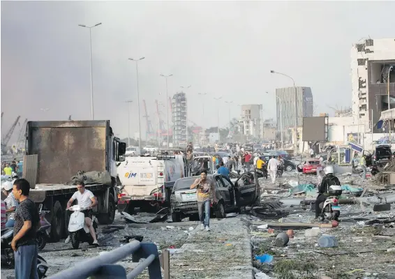  ??  ?? The explosion in Beirut’s port damaged buildings and wrecked vehicles. A security official said it could have been caused by highly explosive material that had been confiscate­d from a ship and stored at the port.