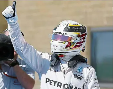  ?? — AP ?? Great run: Mercedes’ Lewis Hamilton reacts after winning pole position for the US Grand Prix on Saturday.