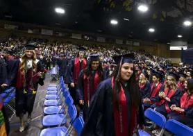  ?? Alex Mcintyre, Greeley Tribune ?? A row of graduates get up to wait in line to receive their diplomas during the Northridge High School commenceme­nt ceremony at the University of Northern Colorado in Greeley on May 20.