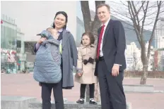  ?? — AFP ?? Robert Kelly, an expert on East Asian affairs and a professor at South Korea’s Pusan National University, his wife Kim Jung-A, daughter Marion (2nd R) and toddler son James pose at the university in Busan.