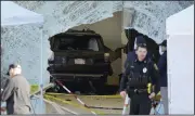  ?? (AP/Steven Senne) ?? An SUV sits inside an Apple store after crashing through the front window of the store Monday in Hingham, Mass.