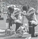  ??  ?? Los Angeles Chargers players kneel in the end zone before kickoff of their game against the Philadelph­ia Eagles on Oct. 1 at StubHub Center in Carson, Calif.