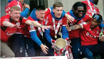  ?? PA ?? Red-letter day: Forest players (main) and fans (left) unite to celebrate their promotion