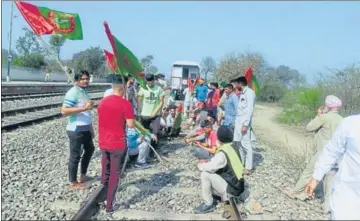  ??  ?? Activists of the BKU (Krantikari) blocking a freight train at the Dagru railway station in Moga district on Friday.