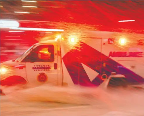  ?? FRANK GUNN / THE CANADIAN PRESS ?? An ambulance races through a storm in Toronto on Monday. The latest numbers from the OECD show Canada with
just one hospital bed for every 400 citizens, a ratio that put the country in the bottom tier of OECD countries.