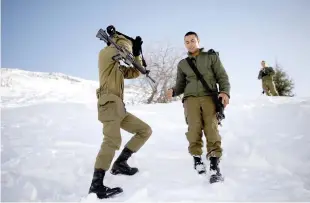  ?? (Amir Cohen/Reuters) ?? IDF SOLDIERS stand on a snow-covered Mount Hermon on the Golan Heights on January 21, 2019.