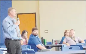  ?? Westside Eagle Observer/MIKE ECKELS ?? Steve Watkins (left) delivers his annual welcome back address to teachers and staff gathered in the cafeteria on Aug. 10 for the Decatur district’s annual breakfast. Seated next to Watkins is Jacque Smith, athletic director (second from left); Daniel Meyer, middle school principal; Devon Courtney, elementary principal; and Toby Conrad, high school principal.