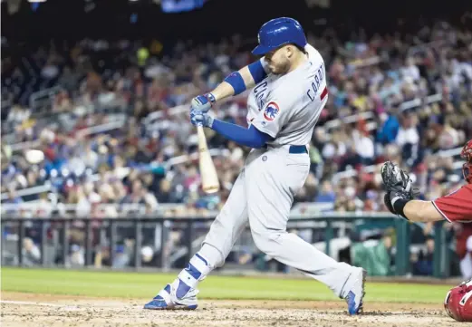  ?? SCOTT TAETSCH/GETTY IMAGES ?? Victor Caratini socked a grand slam in the fourth inning of Game 2 against the Nationals on Saturday. The Cubs dropped the first game 10-3.