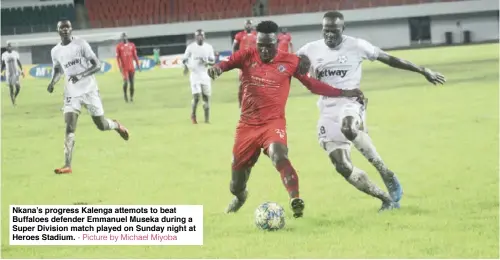  ?? - Picture by Michael Miyoba ?? Nkana’s progress Kalenga attemots to beat Buffaloes defender Emmanuel Museka during a Super Division match played on Sunday night at Heroes Stadium.