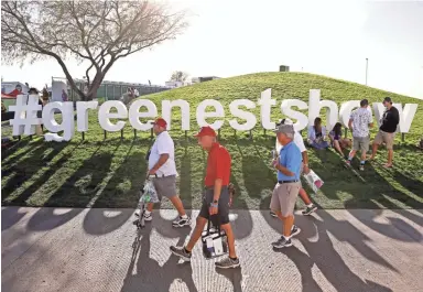  ??  ?? Golf spectators walk past the #greenestsh­ow display at TPC Scottsdale on Thursday, when the opening round of the Waste Management Phoenix Open was played. Find scores and more in PATRICK BREEN/THE REPUBLIC