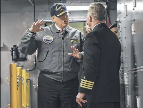  ?? PABLO MARTINEZ MONSIVAIS / ASSOCIATED PRESS ?? President Donald Trump talks with Capt. Richard “Rick” McCormack during a tour of the nuclear aircraft carrier Gerald R. Ford, Thursday at Newport News Shipbuildi­ng in Newport News, Va.