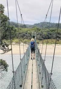  ??  ?? Swing bridge at Maori Beach.