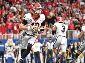  ?? HYOSUB SHIN/HYOSUB.SHIN@AJC.COM ?? Stetson Bennett was under a good bit of pressure from Alabama on Saturday. He was sacked three times for a total of 17 yards in losses, including 10 yards on one play. Without the sacks, he averaged 7.0 yards rushing on four runs.