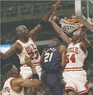  ?? MARK ELIAS/AP FILE ?? Horace Grant, right, says if there was one thing the ESPN documentar­y The Last Dance “proved,” it was that former Bulls teammate Michael Jordan, second from left, had a tendency to hold “a grudge.”