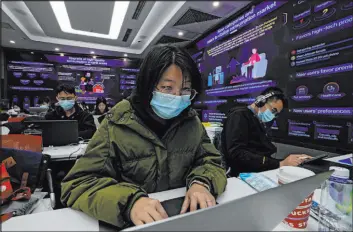  ?? Andy Wong The Associated Press ?? Workers set up Tuesday for China’s biggest online shopping day — “Singles’ Day,” also known as Double 11— at retailer Jd.com in Beijing. “Singles’ Day” is Thursday.