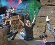  ??  ?? Heiss, top left, leads yoga practition­ers in an undergroun­d class at Olentangy Indian Caverns. Two more sessions will take place Sept. 10 and Oct. 10.