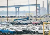  ?? JERRY JACKSON/STAFF ?? A remaining section of the Francis Scott Key Bridge in Baltimore is seen in the distance, beyond the roll-on/roll-off lot at Seagirt Marine Terminal.