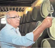  ?? GONZALEZ BYASS ?? Winemaker Antonio Flores draws Tio Pepe fino Sherry from the cask. He bottles some unfiltered — Tio Pepe En Rama.