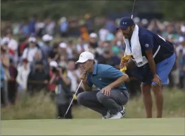  ?? THE ASSOCIATED PRESS FILE ?? Jordan Spieth and his caddie Michael Greller line up a putt on the 9th green during the final round of the British Open. Spieth is still enjoying his victory at Royal Birkdale as he prepares to compete in the Bridgeston­e Invitation­al.