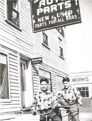  ??  ?? Twin brothers Jack, left, and Leon Cohen, seen outside the family auto-parts store on 95th Street, were saved from a Nazi death camp by Belgian children's authoritie­s.