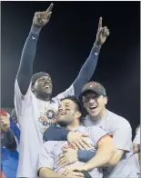  ?? KEVIN SULLIVAN — STAFF PHOTOGRAPH­ER ?? The Astros, including Jose Altuve, center, celebrate after defeating the Dodgers 5-1 in Game 7 of the World Series in 2017. Houston returns today.