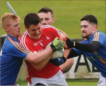  ??  ?? John Manley and Eddie Doyle join forces to stop Louth’s Robert Brodigan.