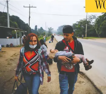  ?? JOSE CABEZAS/REUTERS ?? A family in Quizimista­n, Honduras, take part in a caravan of migrants on Thursday, as a change to asylum rules was published that would prevent many from entering the U.S., including those threatened by gang or gender violence.