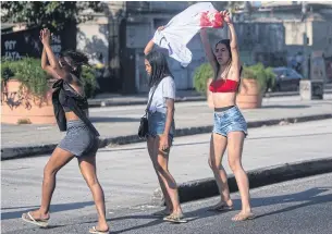  ?? AFP ?? Women holding a bloody T-shirt shout at policemen outside the Getulio Vargas Hospital, after a police operation at a favela in Rio de Janeiro, Brazil on Tuesday.