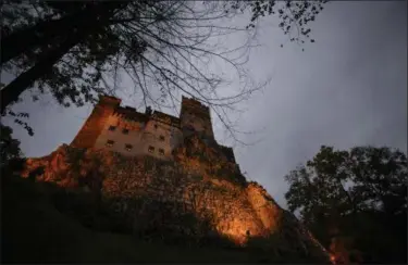  ?? PHOTOS BY ANDREEA ALEXANDRU — THE ASSOCIATED PRESS ?? Bran Castle lies on top of cliffs in Bran, Romania on Oct. 9. Airbnb has launched a contest to find two people to stay overnight in the castle on Halloween, popularly known as Dracula’s castle because of its connection to the cruel real-life prince...