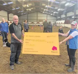  ??  ?? Leading lights Christine (far left) and Robert Hague, and TT dog training school owner Natasha Davies, with the cheque for Maggie’s Lanarkshir­e