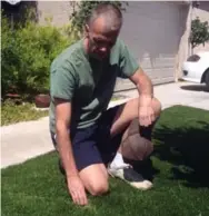  ?? JOHN M. GLIONNA/TRIBUNE NEWS SERVICE ?? Ron Newsome recently installed artificial grass at his north Las Vegas home to conserve water.